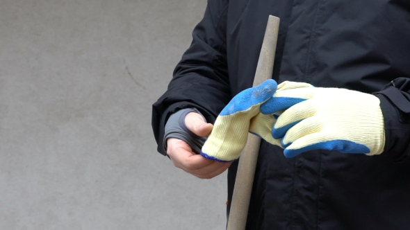Footage Worker Man Holding a Shovel And Put The Gloves