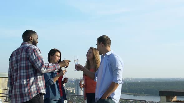 Successful Young People Drinking Cocktails on Roof, Celebrating Victory Together