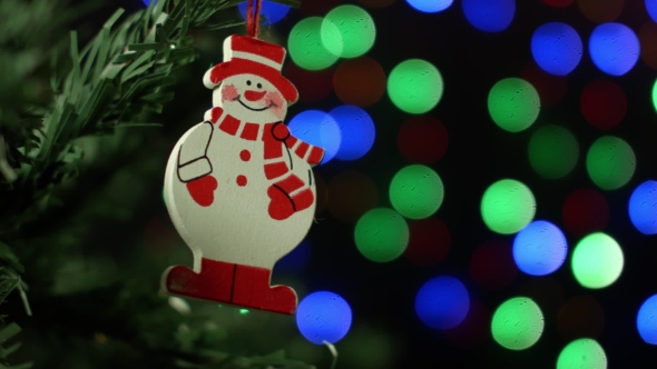 Christmas Background With Christmas Tree And Snowman On Background Of Blurred Lights Garlands