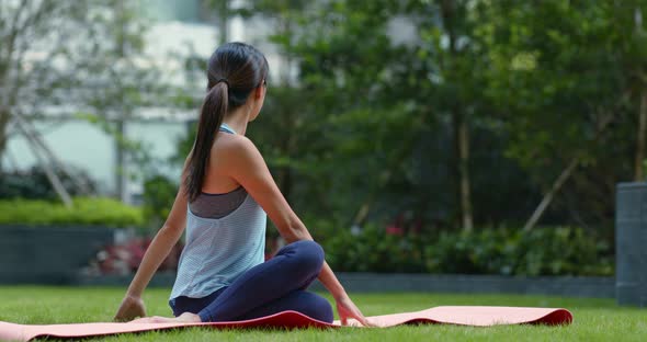 Woman do yoga at the park