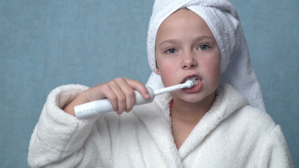 Girl Cleaning Teeth With Electric Toothbrush