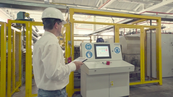 Engineer Is Checking Settings Of CNC Machine