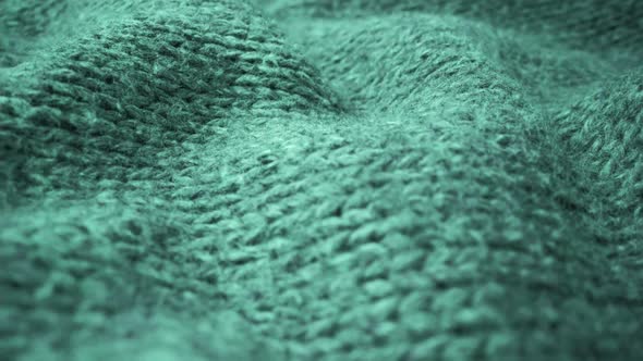 Extreme detail view of sheep wool cloth texture flowing in macro dolly shot.