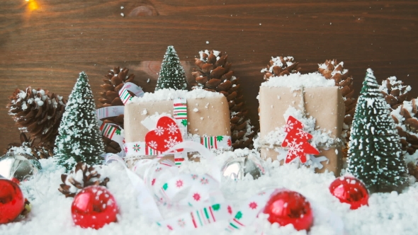 Christmas And New Year Background With Decorations, Snow, Fir Trees, Presents And Lights.