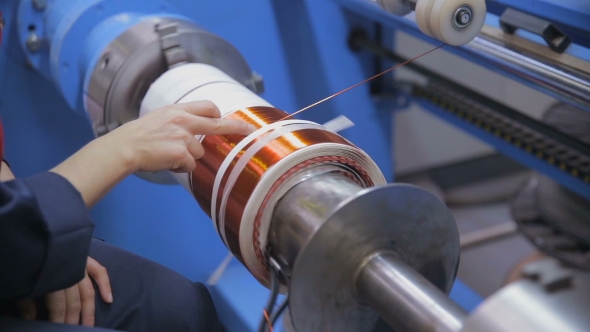 Transformer, Engine Production. Worker Winding Cooper Wires On a High Voltage Transformer. Slider