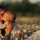 Slow Motion of a Young Happy Mother and Child in a Flower Field at Sunset - VideoHive Item for Sale