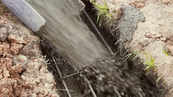 Flowing Cement Closeup on the Foundation of the Cottage During Construction Close Up