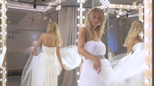 Lovely Bride Dancing Near Mirror In Wedding Dress