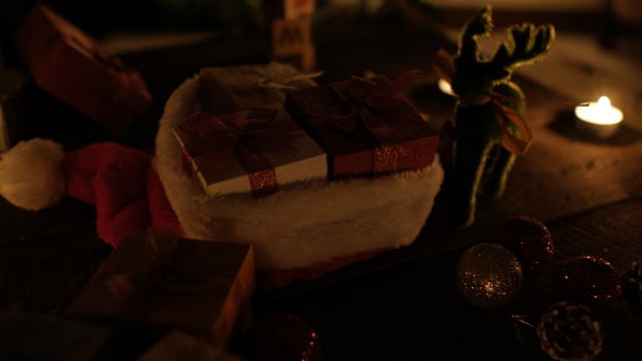 Christmas Gifts In Santa Hat On Wood Desk