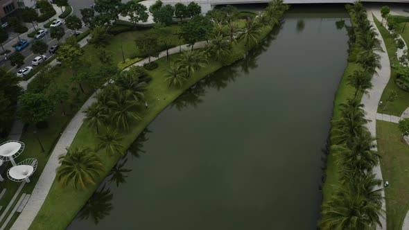 Aerial view flying over beautiful contemporary landscaping and bridge in  a new luxury development i