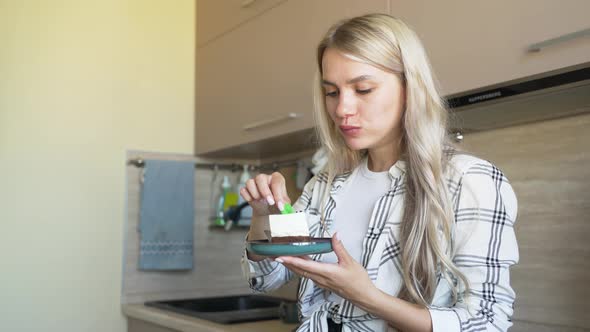 Delicious Cake on a Saucer Spoon Breaks Off a Piece