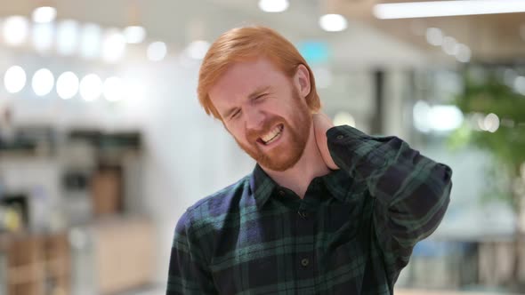 Portrait of Stressed Beard Redhead Man Having Neck Pain