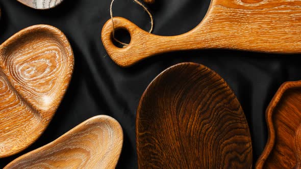 Rich Variety of Wooden Empty Cutting Boards and Plates on Dark Background.