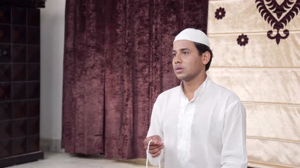 Muslim man praying beads