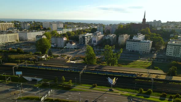 Train Parked At The Maksymiliana Railway Station Overlooking The Tower Of Saint Anthony Parish Churc