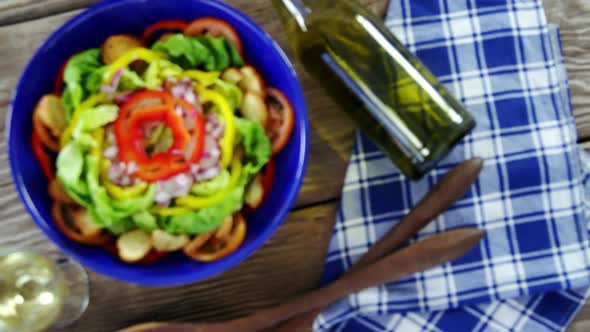 Salad with wine on wooden table