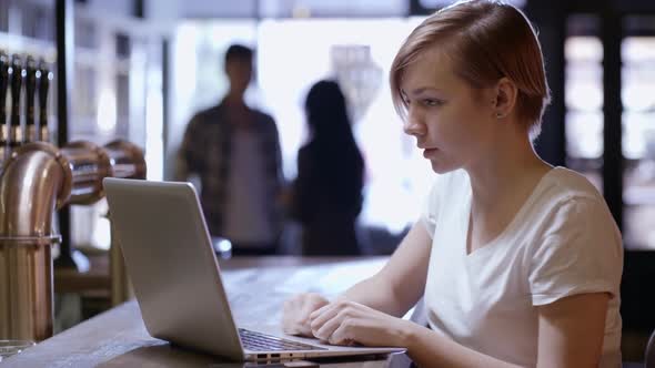 Woman Talking on Video Call at Bar