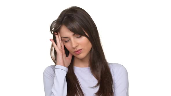 Tired and Unhappy Caucasian Female Suffering Terrible Headache Standing Over White Background in
