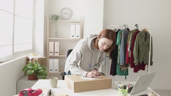 Small Business Female Owner Delivering Package to Customer From Workplace