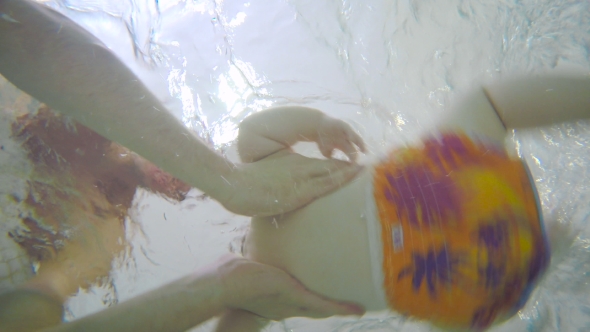 The Man Moving The Baby In The Child Pool: Underwater