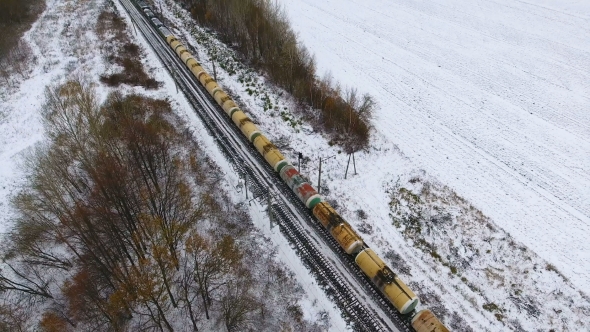 Freight Train On The Railway In Winter. Gasoline, Fuel Tanks. Aerial Shot. alt
