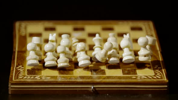 White chess pieces falling on chess board, Ultra Slow Motion