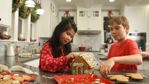 Decorating gingerbread house for Christmas