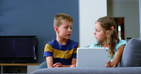 Siblings interacting with each other in living room