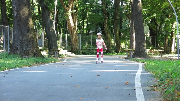 Rollerblading In The Park. Girl Rides On Roller Skates. On Rollers On a Track.