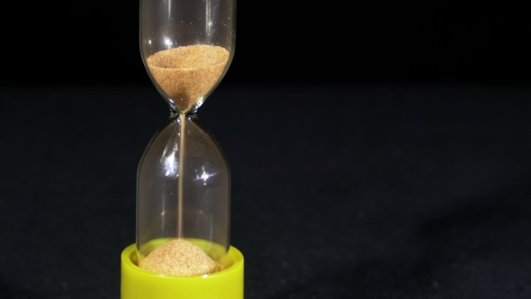 Hourglass On a Black Background, The Sand Falls Inside alt