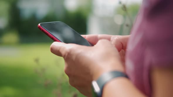 Woman Using Smartphone Pressing Finger Reading Social Media and Typing Text or Shopping Online