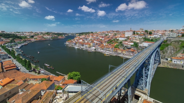 View Of The Historic City Of Porto, Portugal With The Dom Luiz Bridge . A Metro Train Can Be Seen On