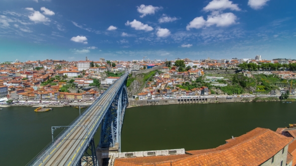 View Of The Historic City Of Porto, Portugal With The Dom Luiz Bridge . A Metro Train Can Be Seen On