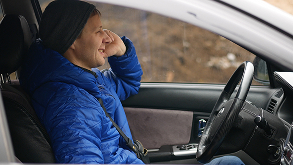 Man Speaking on the Phone in the Car