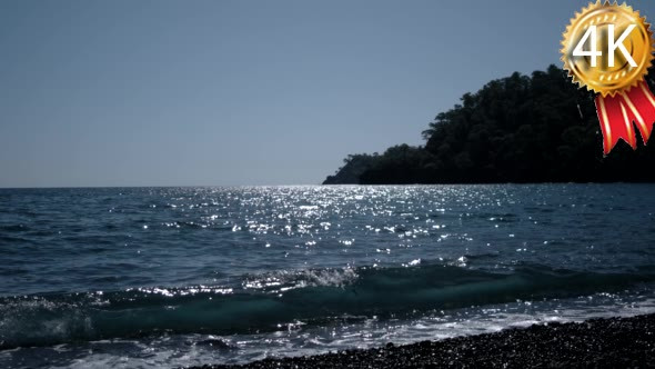 Sparkling Wavy Sea Water is Shining on a Sunny