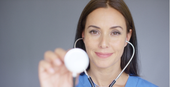 Attractive Young Nurse Using a Stethoscope