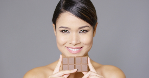 Beautiful Smiling Woman Holding Chocolate