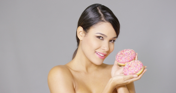 Gorgeous Smiling Woman Holding Donuts