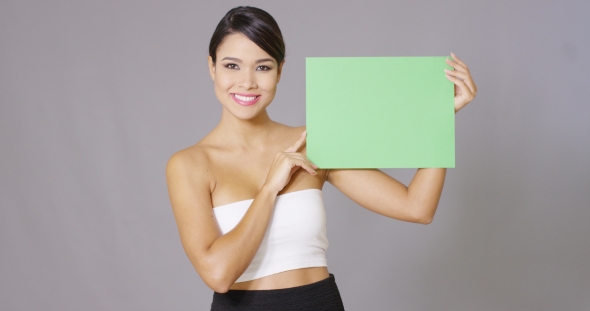 Attractive Woman Holding a Blank Green Sign