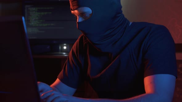 a Man in a Balaclava Police Raiding Cybercrime