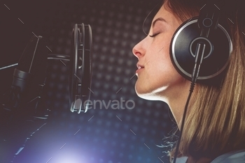 Caucasian Singer in Her 20s Recording Album in the Professional Studio. Singing with Passion.