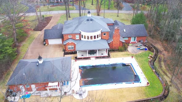 Aerial view of ranch style house in suburban neighborhood with swimming pool in it, in Missouri, Mid