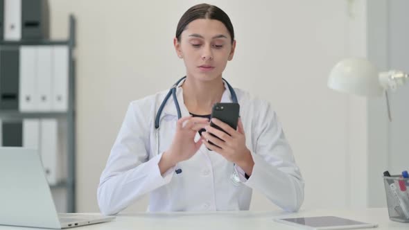 Female Doctor Using Smartphone at Clinic
