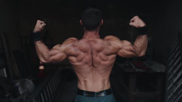 Back Close View of a Male Bodybuilder Showing His Muscled Arms