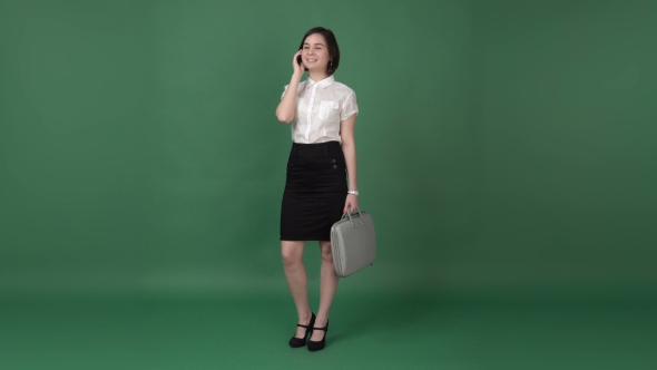 Nice Brunette Woman in Business Clothes Talking on the Phone