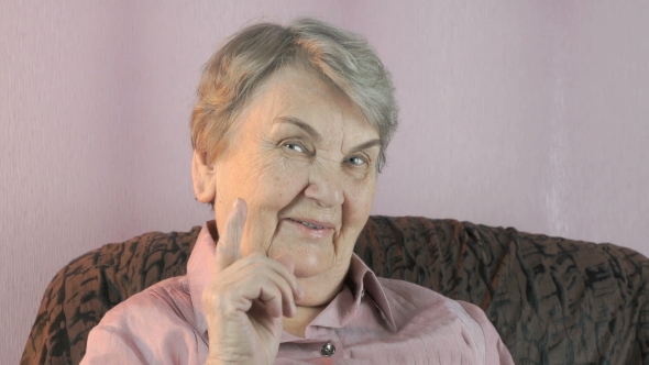 Aged Woman Waves Her Index Finger in Front of Face