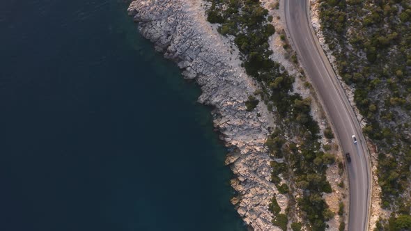 Fast Motion of Cars Driving on Mountain Road Near the Sea or Ocean