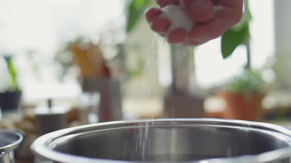 Adding Salt to Water in Pot