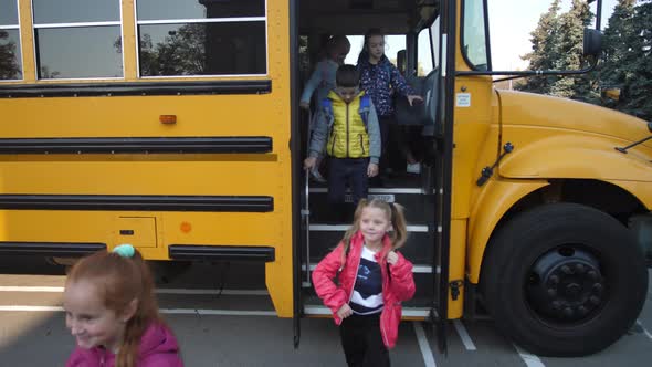 Little Pupils Getting Off Bus and Going To School