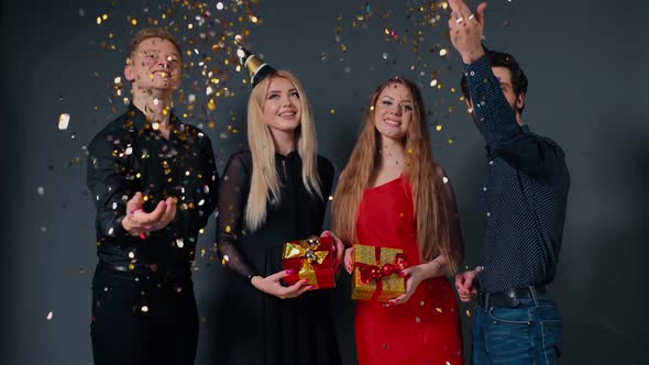 Two Beautiful Young Women Are Holding Bright Gift Boxes in Hands